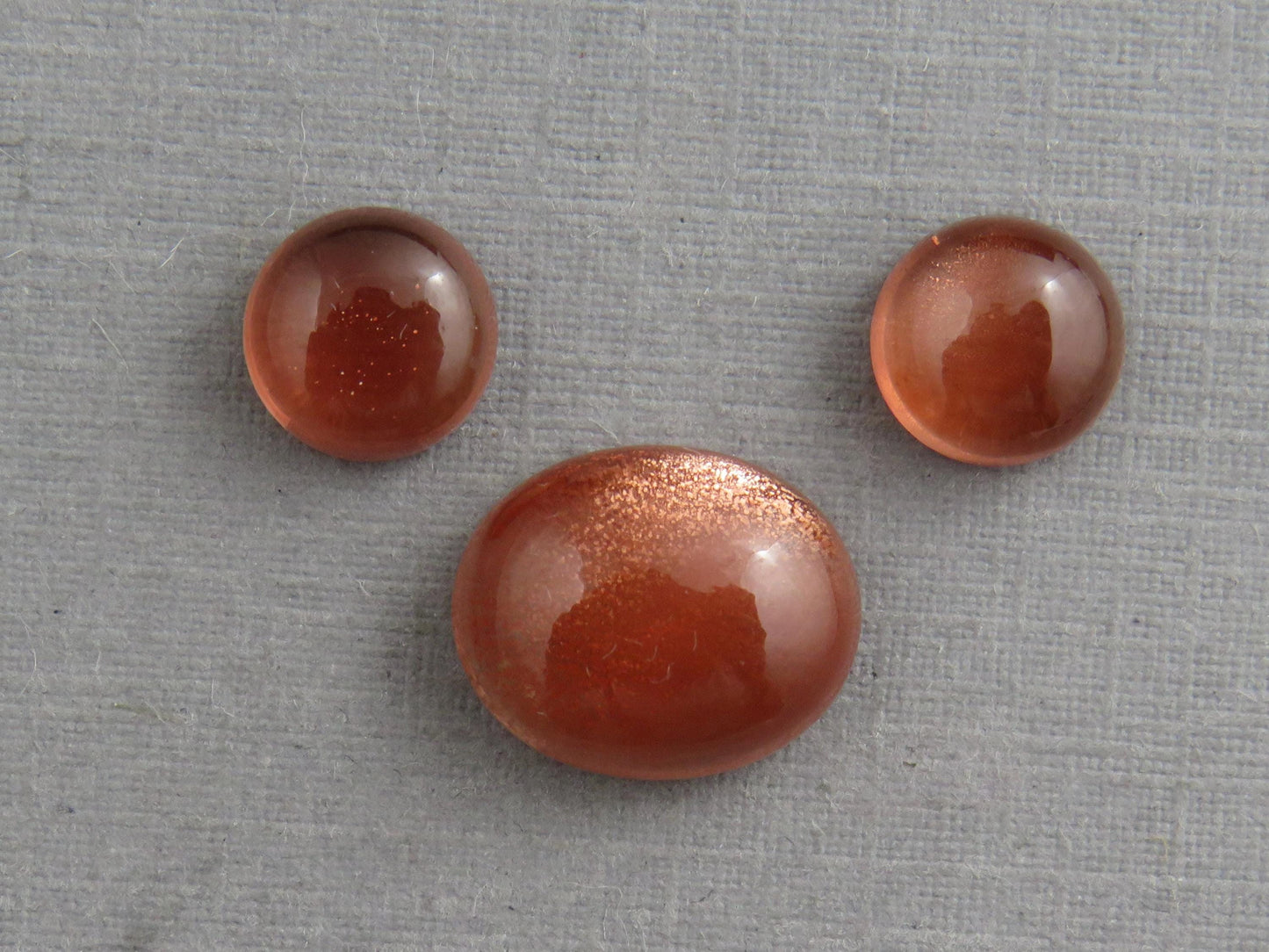 Oregon Sunstones Oval Cabochon Set | 7x7 pair and 11x9 single | 7+ carats | OSC332 - Oregon Sunstone - GemEnthusiast