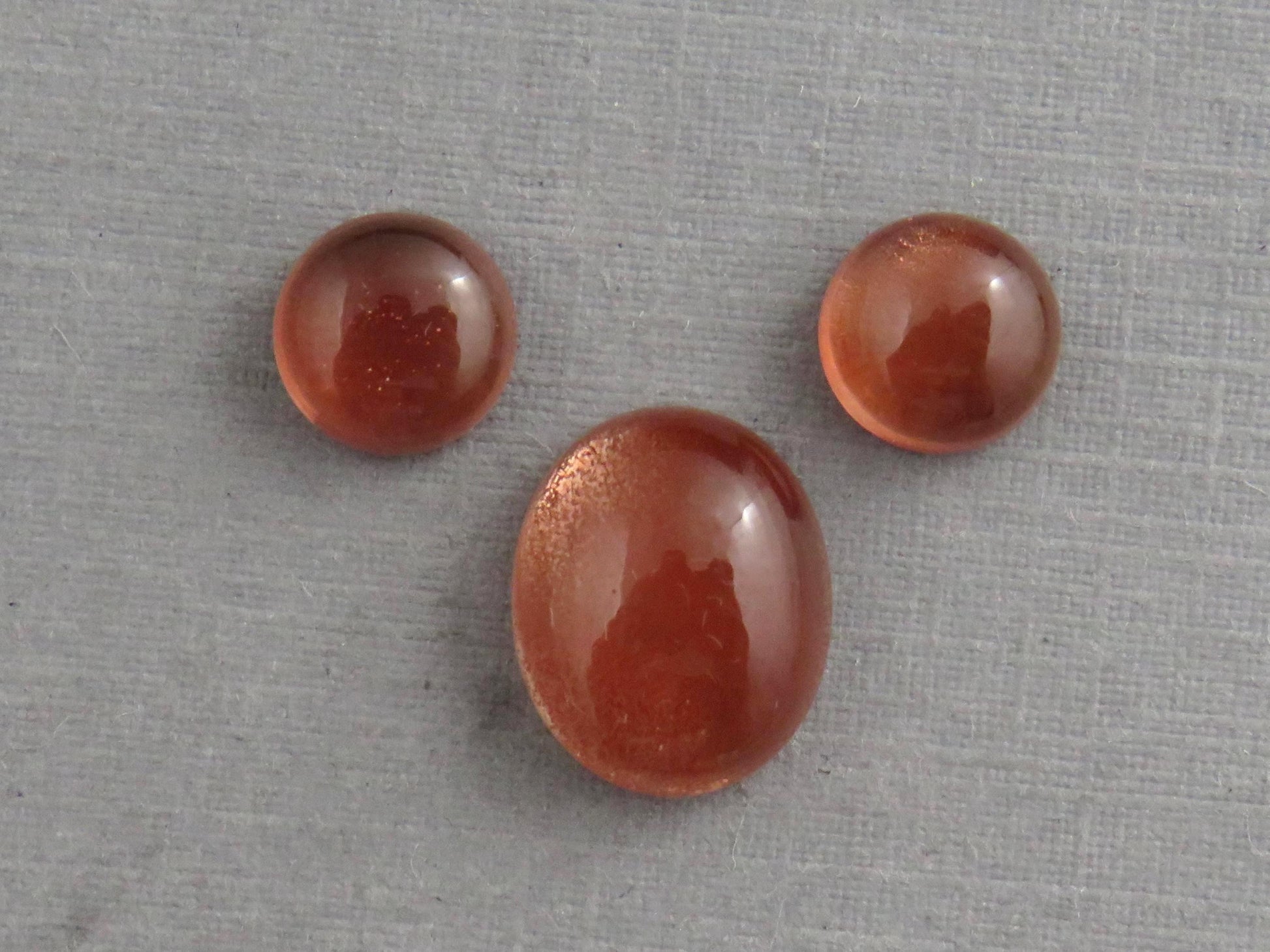 Oregon Sunstones Oval Cabochon Set | 7x7 pair and 11x9 single | 7+ carats | OSC332 - Oregon Sunstone - GemEnthusiast